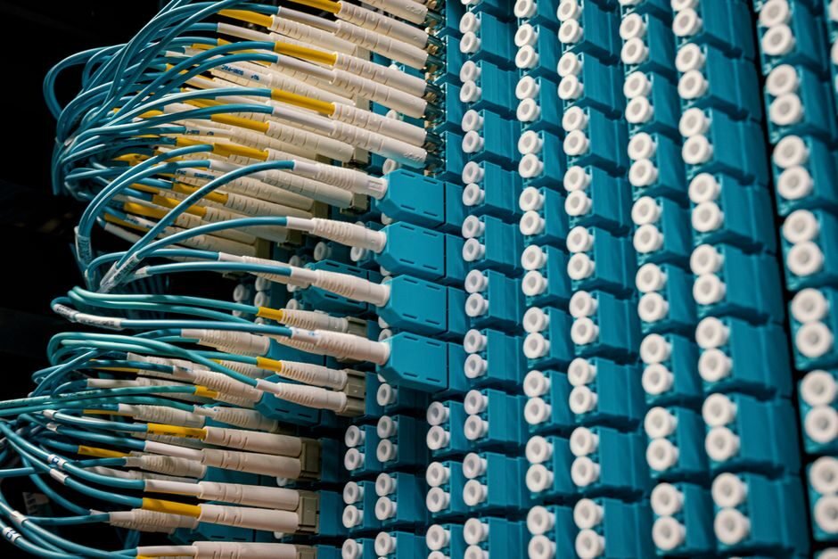 Router and modem set up near a home network panel