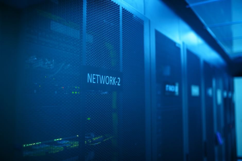 Network administrator configuring firewall settings on a laptop