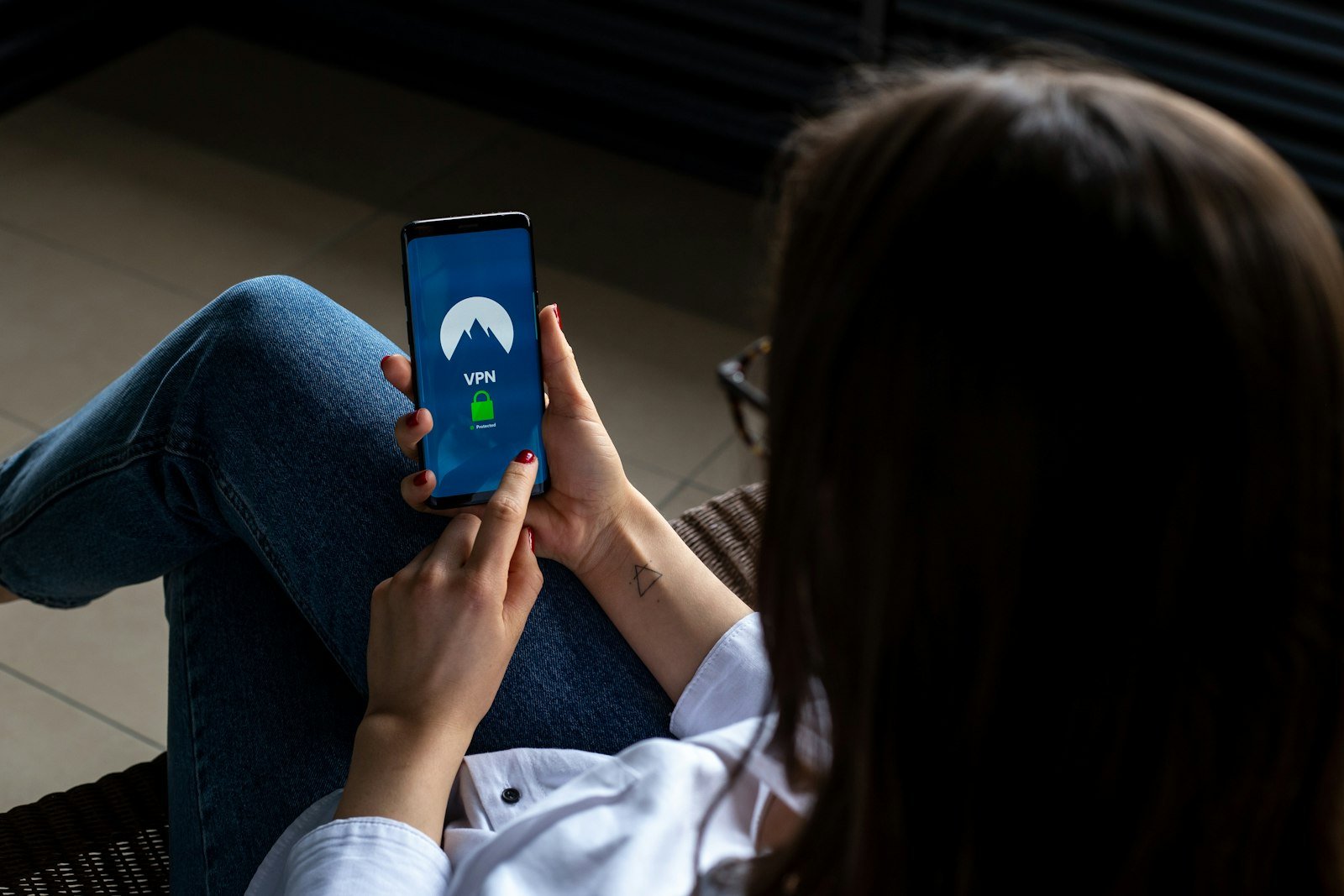 Person using a smartphone app to set up a mesh Wi-Fi system