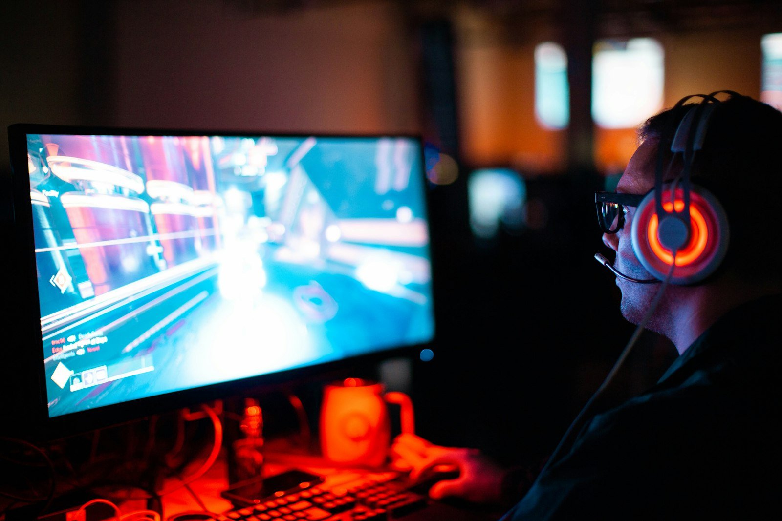 Person gaming on a computer, where ping and jitter matter most
