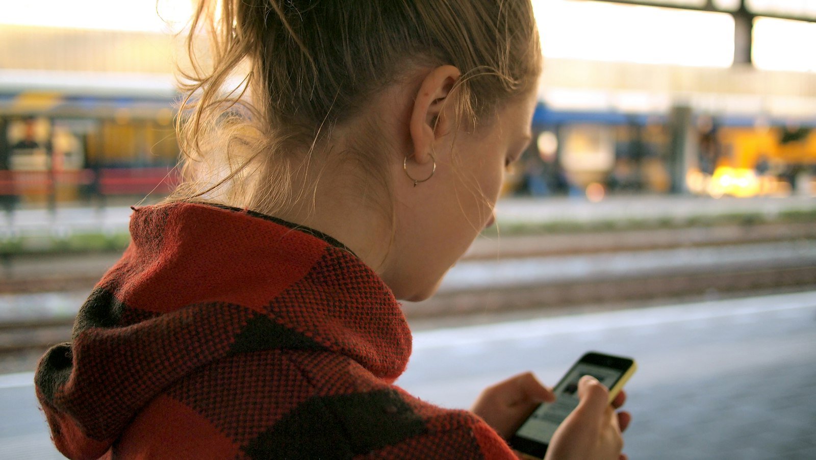 Traveler holding a phone, using a travel eSIM instead of a local SIM card