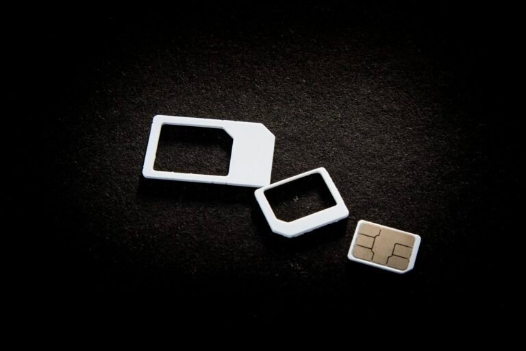 eSIM vs physical SIM: physical SIM cards and adapters laid out on a table